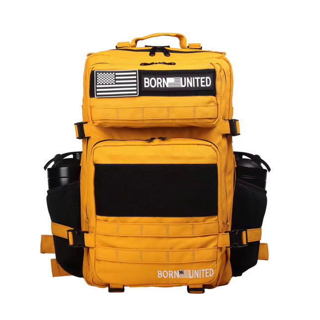 A bright yellow backpack with black zippers, side pockets holding water bottles, and patch designs reading BORN UNITED with a stylized American flag on the front.