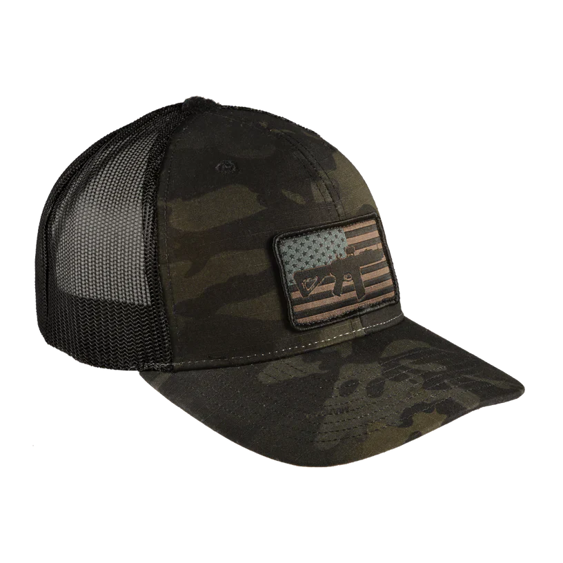 The Range Trucker Hat by Black Rifle Coffee is a camouflage cap with a black mesh back. Made from durable NYCO ripstop fabric, it includes an adjustable snapback and a front patch displaying Texass outline over a stylized, subdued-color American flag.
