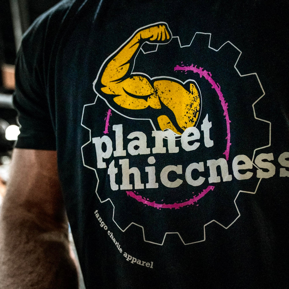 tango charlie - planet thiccness black tee shirt on model