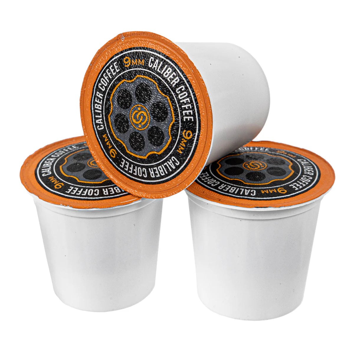 Three white Medium Roast 9MM Single-Serve Shells from Caliber Coffee Company, featuring orange lids with circular designs and text Caliber Coffee and 9MM, are stacked in a pyramid against a white background, perfect for a Colombian coffee experience.