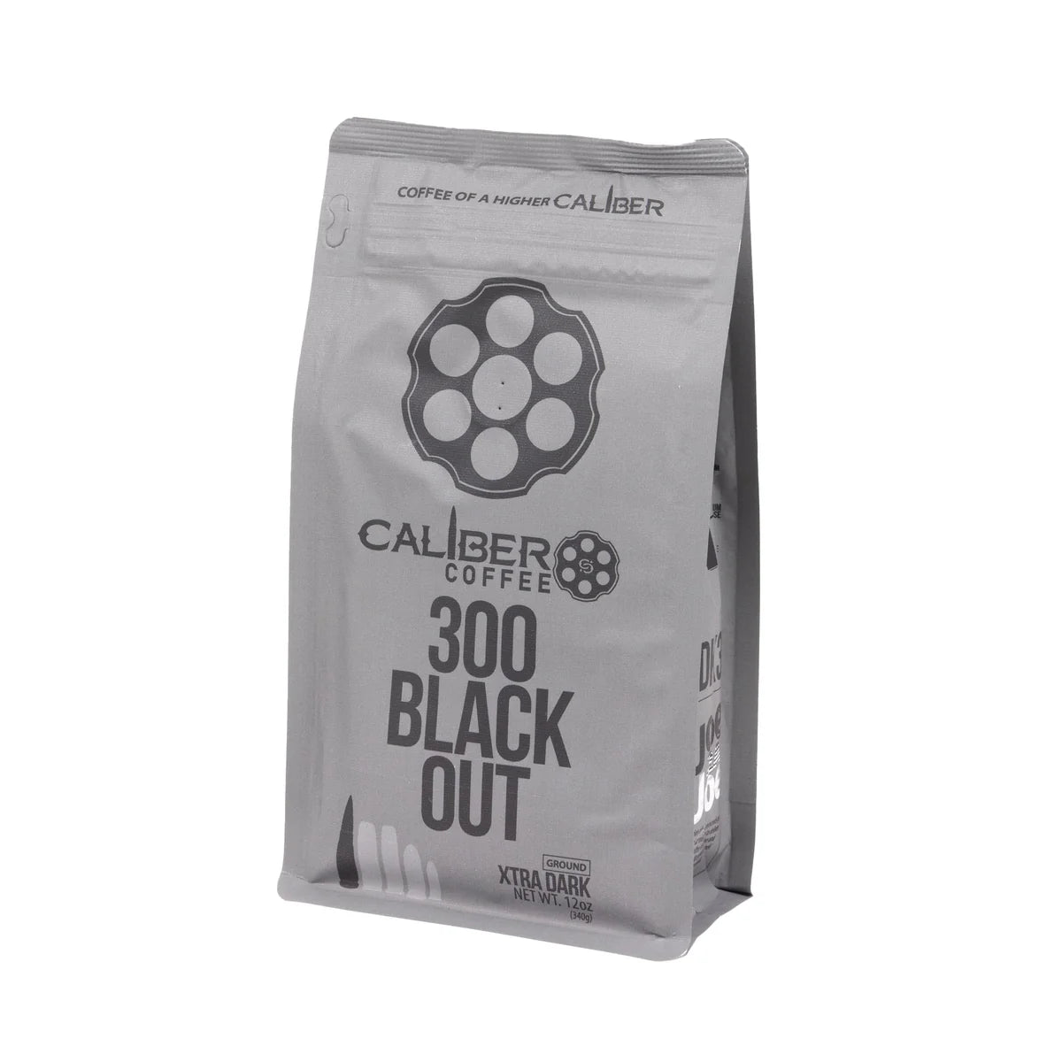 A gray coffee bag with Caliber Dark Roast 300 Blackout - Ground text and a revolver chamber design features Coffee of a higher caliber and Xtra Dark. Made from Specialty Grade, Single Origin South American beans, it stands upright. Brand: Caliber Coffee Company.