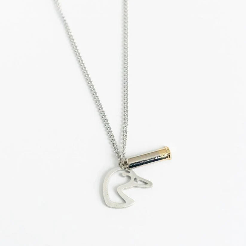 The Mallard Duck Shot necklace by Mucker Bucket features a stainless steel chain with two pendants: a small silver animal head and a cylinder with a gold tip. Made in the USA, it is set against a plain white background.