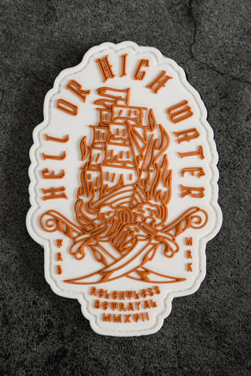 The Hell or High Water PVC Patch by Relentless Betrayal features a ship in flames with crossed swords, an orange and white nautical theme, Hell Or High Water text, smaller inscriptions, and the Roman numerals MMXVII.