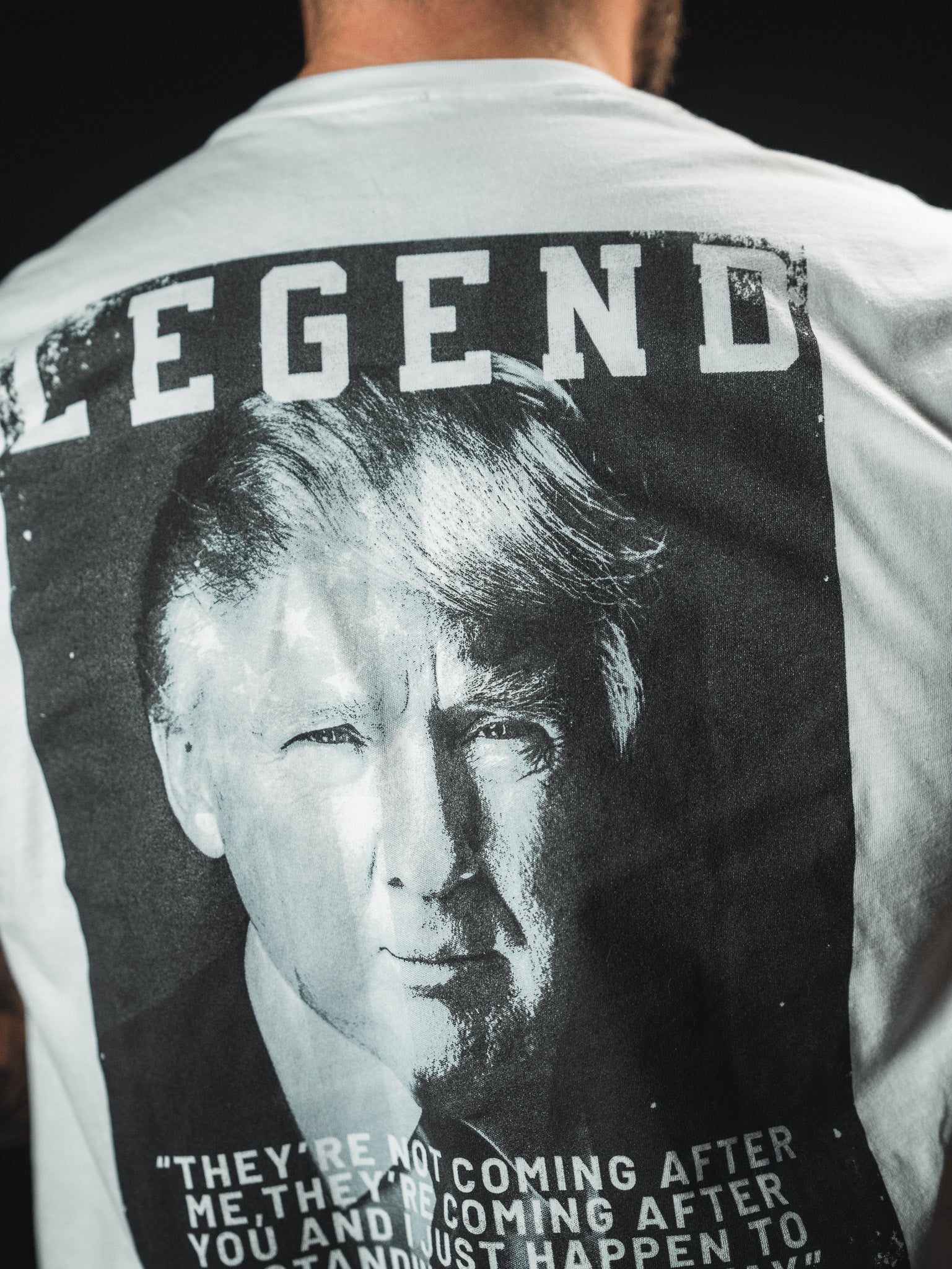 A person wearing a T-shirt featuring a black and white image of a man. Above the image, the word Legend is printed. Text at the bottom reads: They are not coming after me, theyre coming after you and I just happen to...