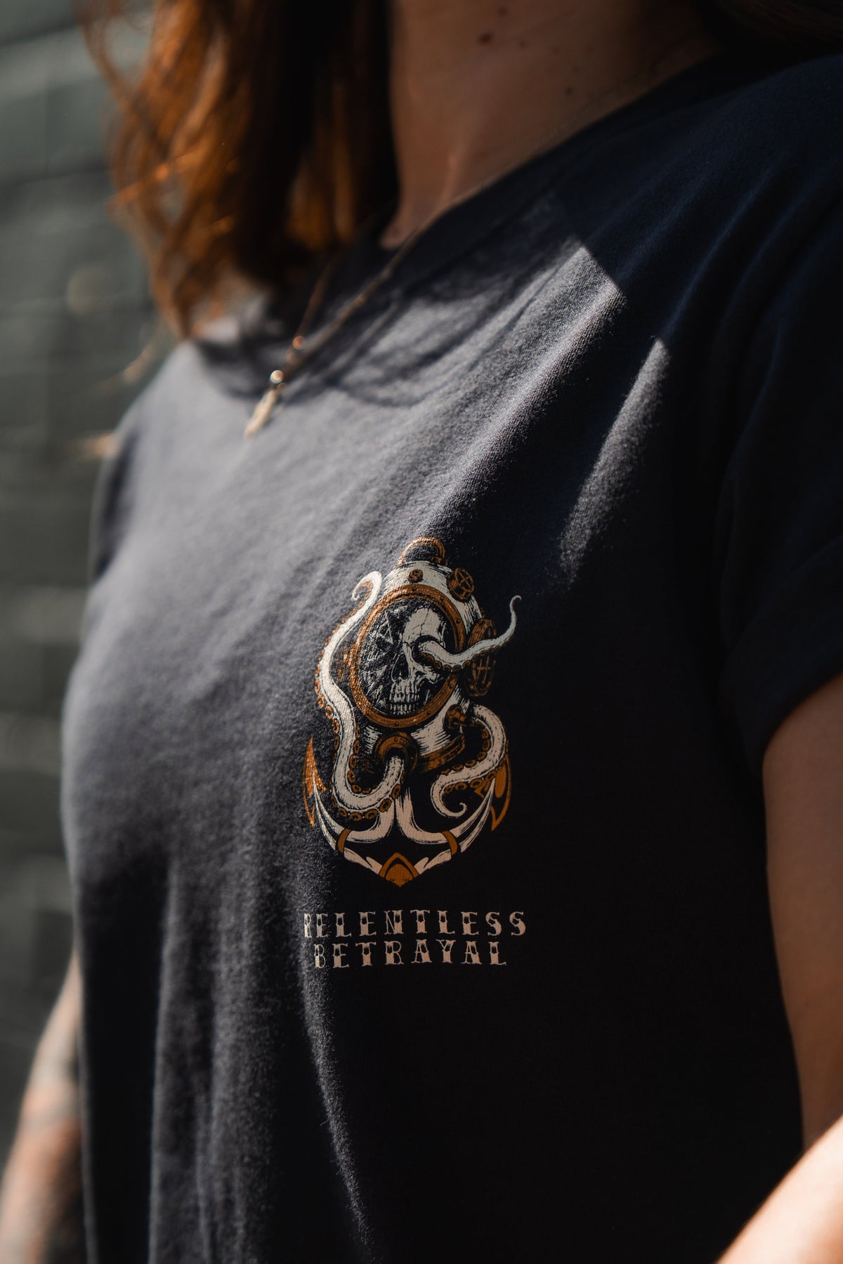 Person wearing the No Safe Harbor Premium T-Shirt by Relentless Betrayal, showcasing a bold octopus and face graphic—a striking nautical-themed tee.