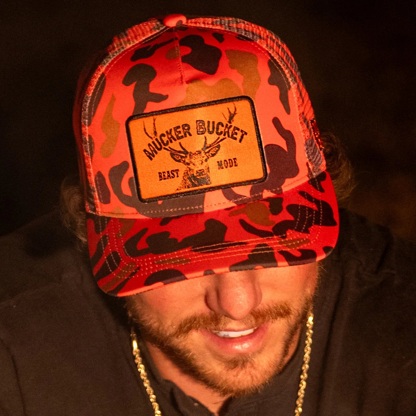 mucker bucket - "beast mode" orange camo trucker hat front