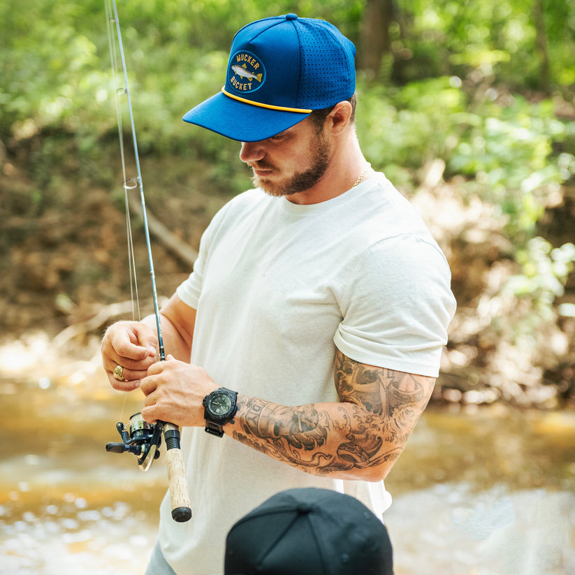 mucker bucket - rainbow trout blue fishing hat on model