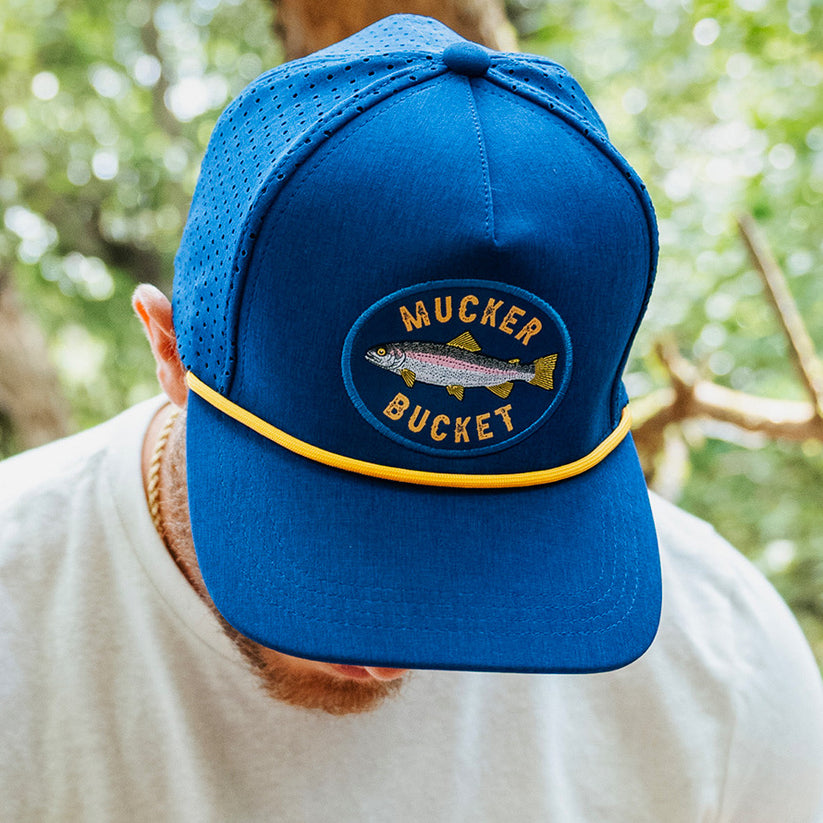 mucker bucket - rainbow trout blue bucket on model front