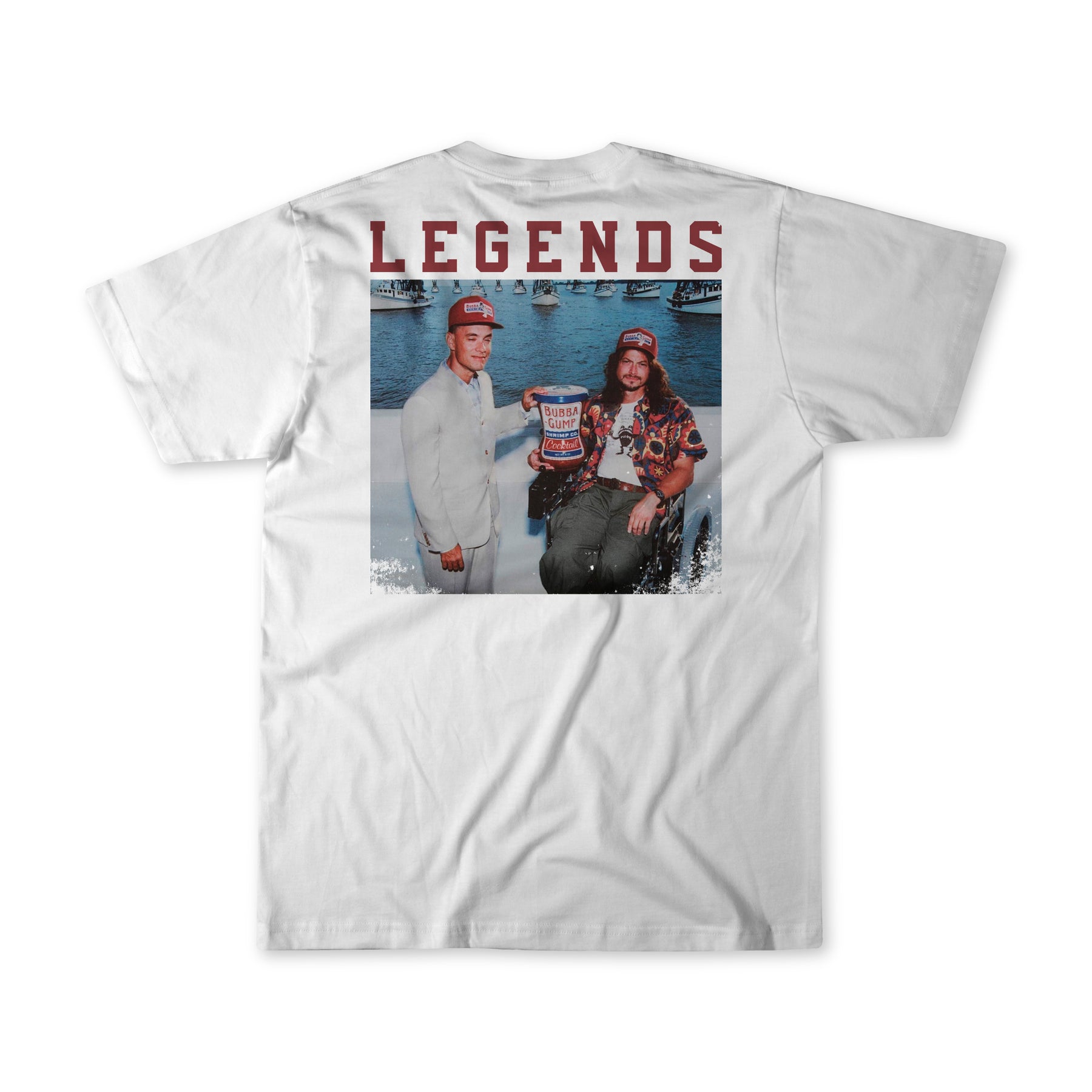 The Legends - Shrimp Co. White T-shirt by Born United Private Label features LEGENDS in bold above an image of two people posing with a championship trophy against a water backdrop, both wearing hats—a tribute to triumph and camaraderie, perfect for celebrating legendary moments.