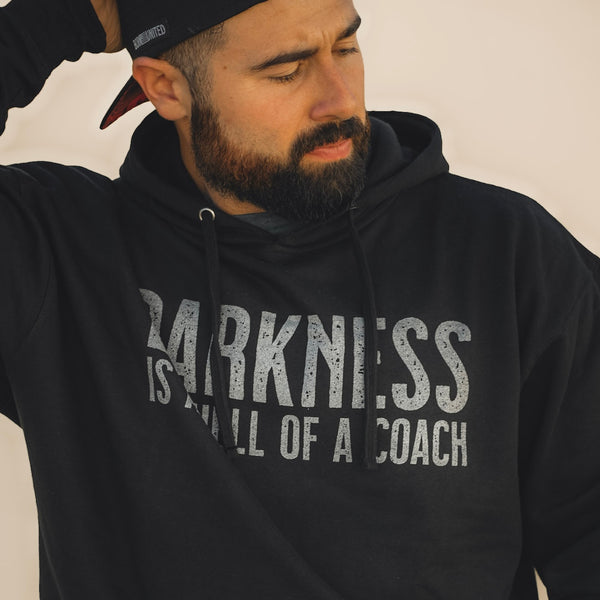 tango charlie - darkness is a hell of a coach hoodie on male model