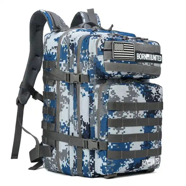 The Arctic Tac-Pac - 45L by Born United Private Label, in digital camo blue, white, and gray, offers multiple compartments and straps. A black and white Born United flag patch adorns the front. Padded shoulder straps guarantee comfort for all your adventures.
