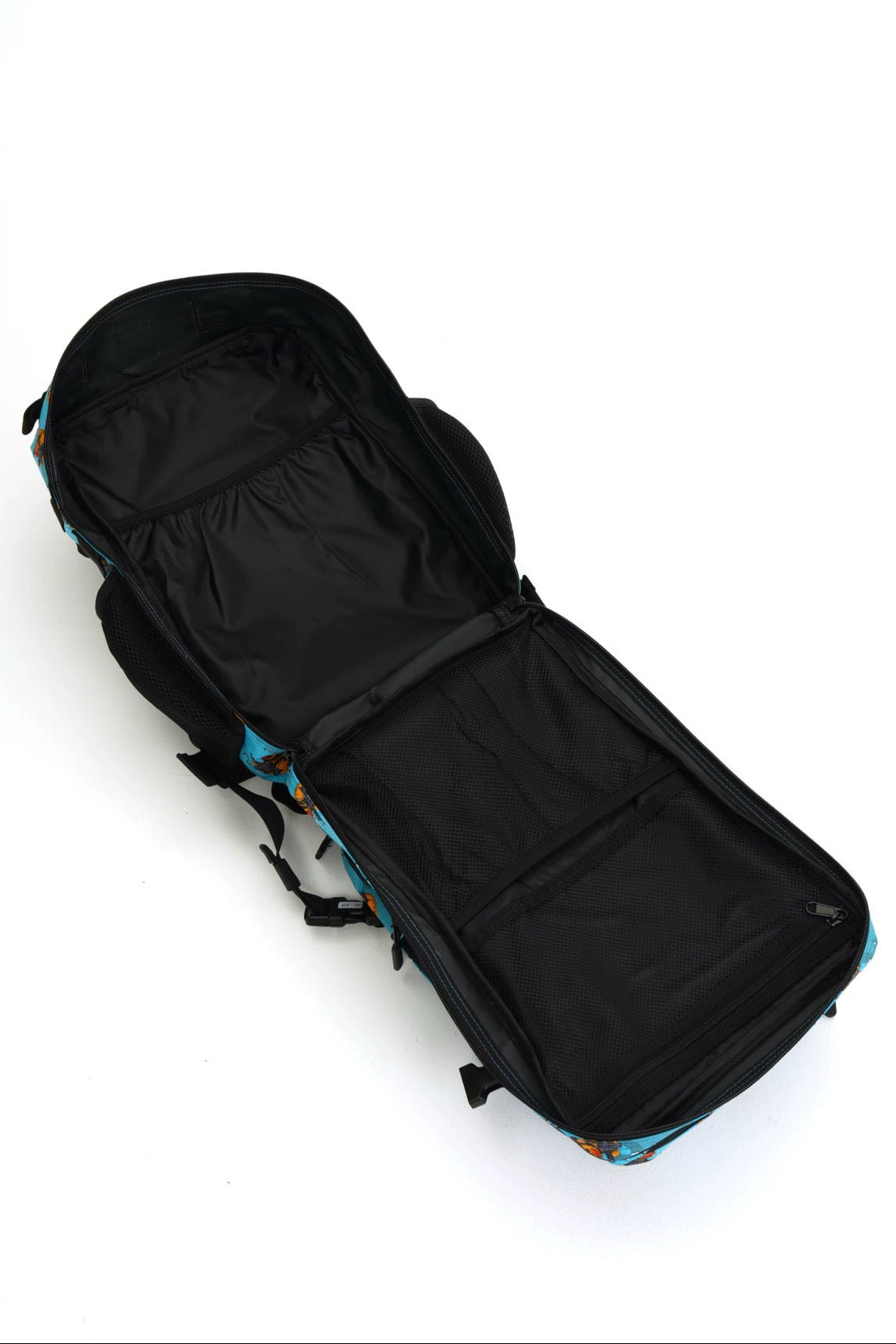 Tactiquack Tac-Pac - 25L tactical backpack with a patterned blue exterior and black interior compartments, shown lying flat.