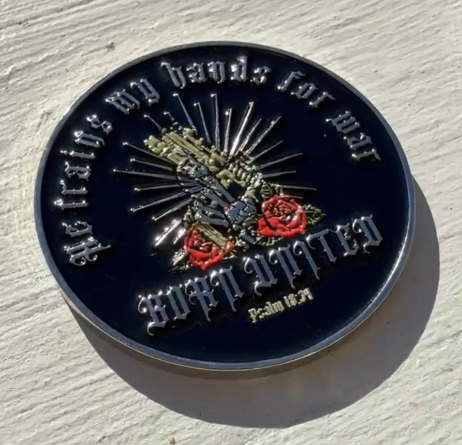 The War Hands Challenge Coin by Born United Private Label showcases a skeleton hand holding a sword, surrounded by roses and radiant rays. In Gothic script, it reads He trains my hands for war and Psalm 18:34.
