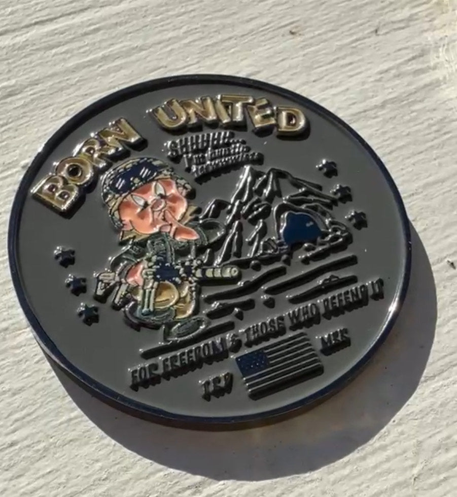 The Huntin Challenge Coin by Born United Private Label features a military figure against mountain scenery, adorned with BORN UNITED and FOR FREEDOM & THOSE WHO DEFEND IT, highlighting an American flag, stars, and numbers—a tribute to heroes; viewing the product description can provide SEO insights.