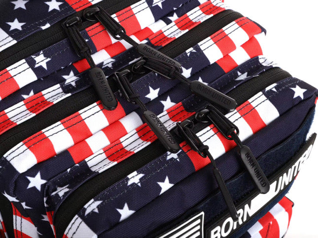 Special Edition close-up of the Ultimate Patriot Special Edition Tac-Pac - 25L by Born United Private Label, featuring a design reminiscent of the American flag with red, white, and blue stars and stripes. Black zipper pulls are visible, each labeled distinctively.