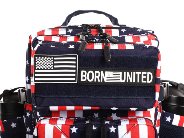 Introducing the Ultimate Patriot Special Edition Tac-Pac - 25L by Born United Private Label, featuring an Americana flag pattern with BORN UNITED text. This unique backpack offers multiple zippers, compartments, and sleek black straps for style and functionality.