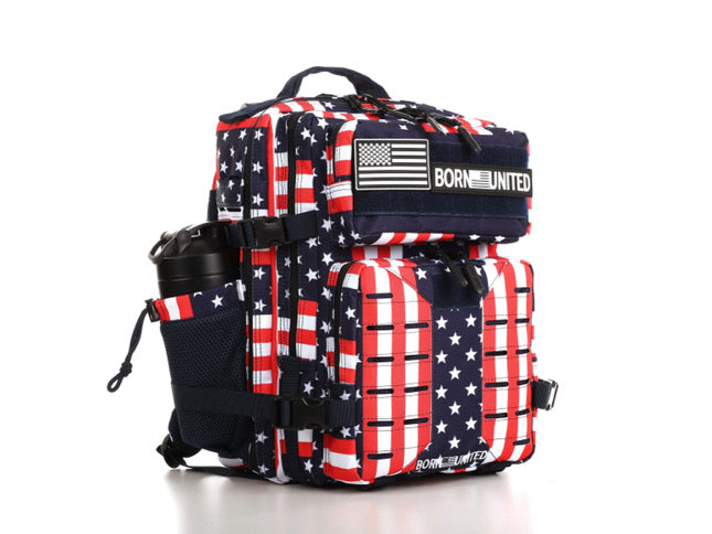 The Ultimate Patriot Special Edition Tac-Pac by Born United Private Label is a 25L backpack with an American flag design in red, white, and blue. It has multiple compartments, a side pocket for a water bottle, and BORN UNITED displayed on the front.