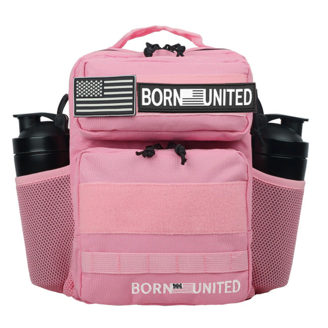 The Pink Mist Premium Tac-Pac - 15L by Born United Private Label is a pink backpack with black accents, featuring an American flag patch and BORN UNITED text, multiple compartments, two side mesh pockets, and elastic cords for added functionality.