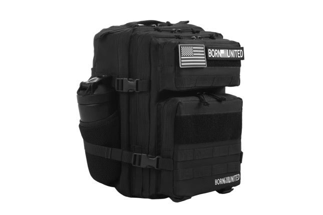 The Midnight Black Premium Tac-Pac - 25L by Born United Private Label is a tactical backpack featuring multiple compartments with zipper closures, a side pocket with a mesh bottle holder, and two patch labels: one showcasing the U.S. flag and the other labeled BORN UNITED.