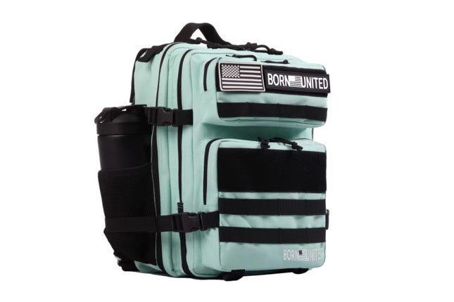 The Mint Condition Premium Tac-Pac - 25L by Born United Private Label is a mint teal tactical backpack with black straps, an American flag patch, BORN UNITED text, multiple compartments, a side water bottle pocket, and a top handle.