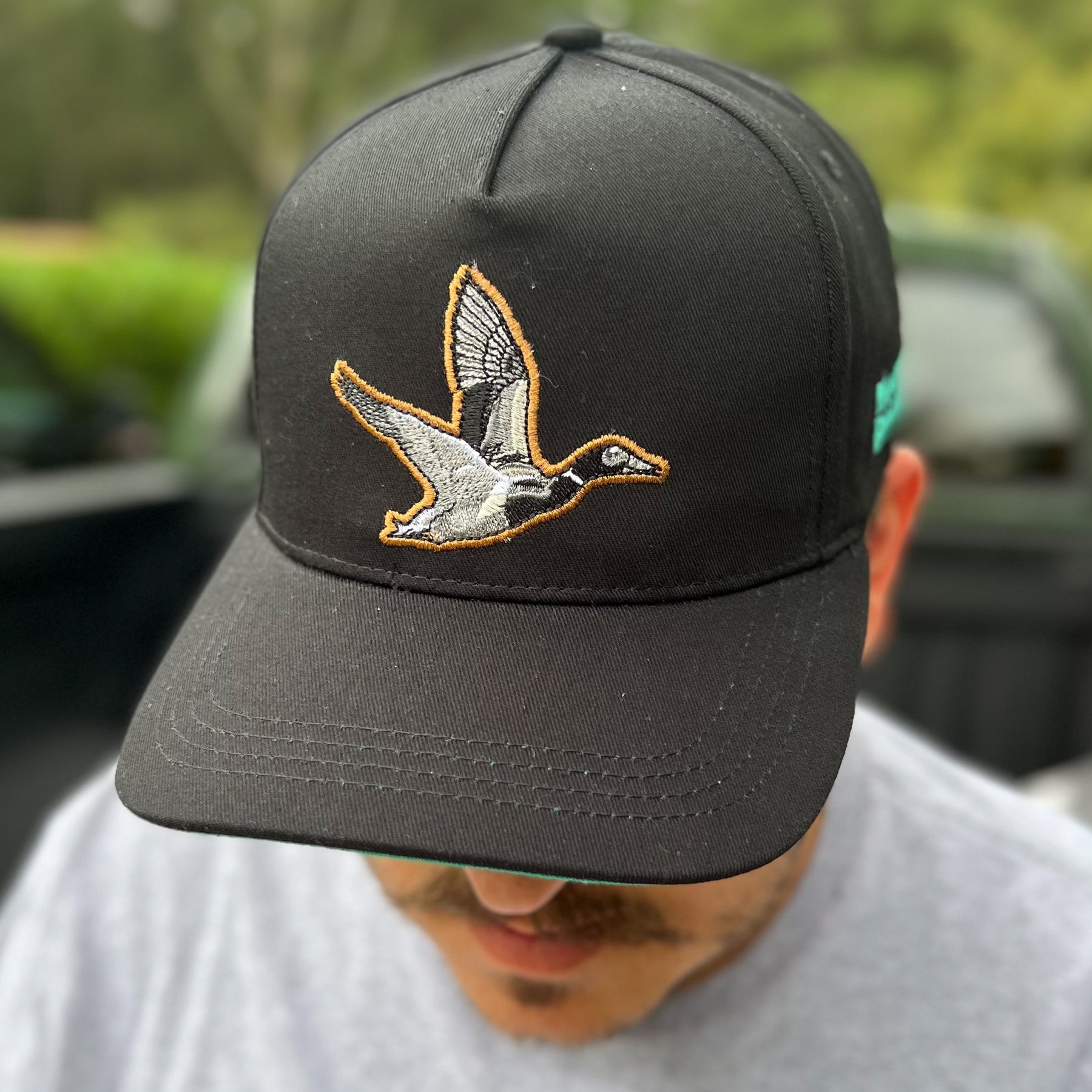 mucker bucket - black duck bucket hat on model