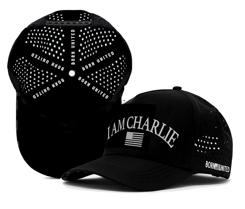 Two black I Am Charlie Black Snapback hats by Born United Private Label, featuring “I AM CHARLIE” and an American flag on the front, and “BORN UNITED” in white inside and on the side. Breathable, handmade 5-panel flat bill design for style and comfort.