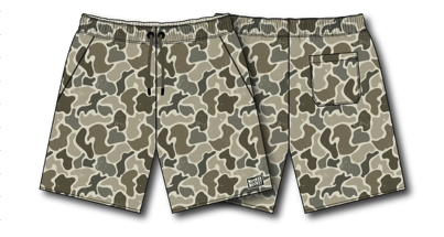 Two pairs of Mucker Bucket Youth Performance Athletic Shorts | Duck It, featuring beige, brown, and green camouflage. One pair has a black waistband with a drawstring and back pocket. Both have a small white tag on the front hem.