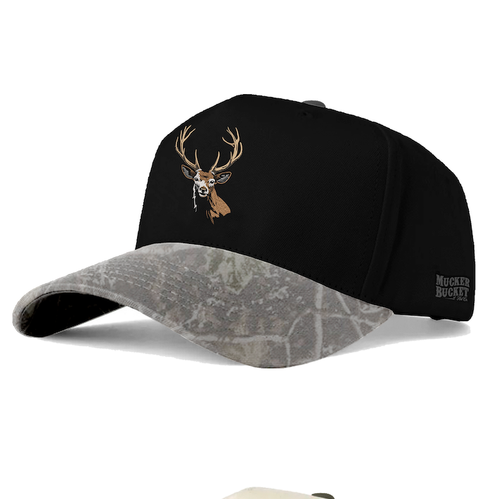 Introducing the Buck Master “After Dusk” Deadwood Bucket by Mucker Bucket—a black and camouflage high-profile hat featuring a bold embroidered deer head on the front and “Mucker Bucket” text on the side. This snapback combines classic style with rugged outdoor flair for any adventure.