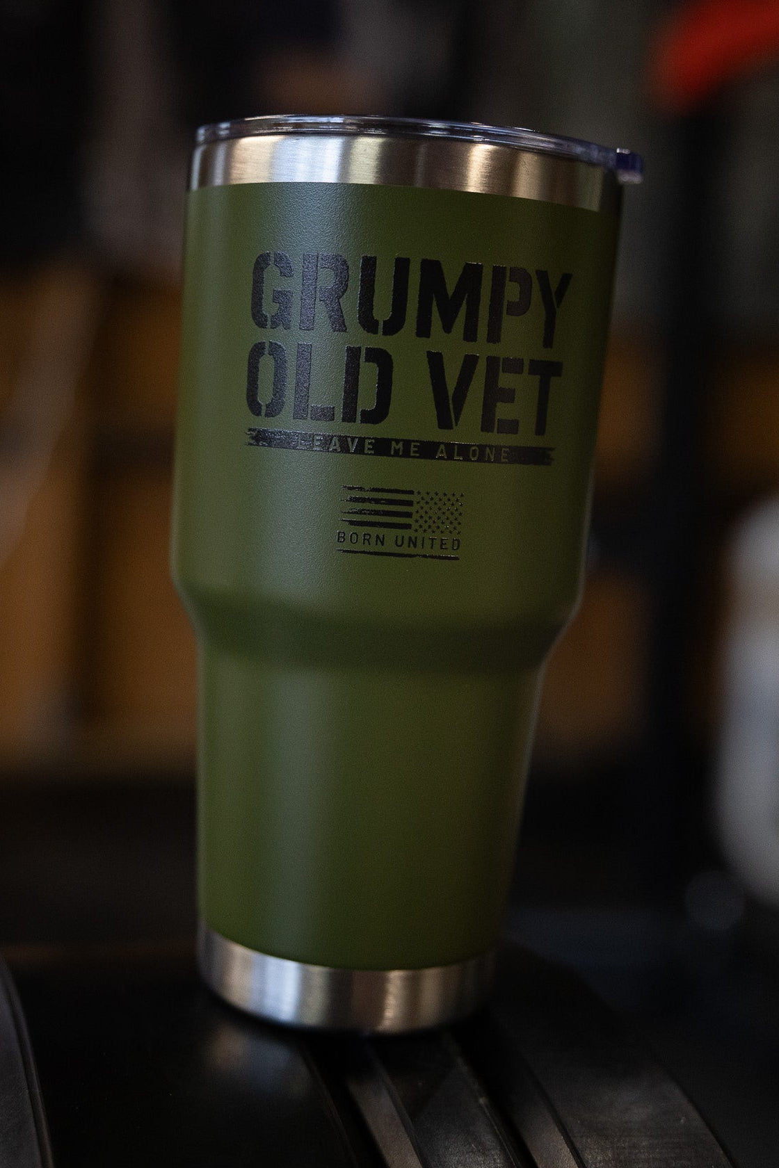 The Grumpy Old Vet Tumbler - 30oz by Born United Private Label features a sleek green and silver design, perfect for keeping your drinks at the ideal temperature.