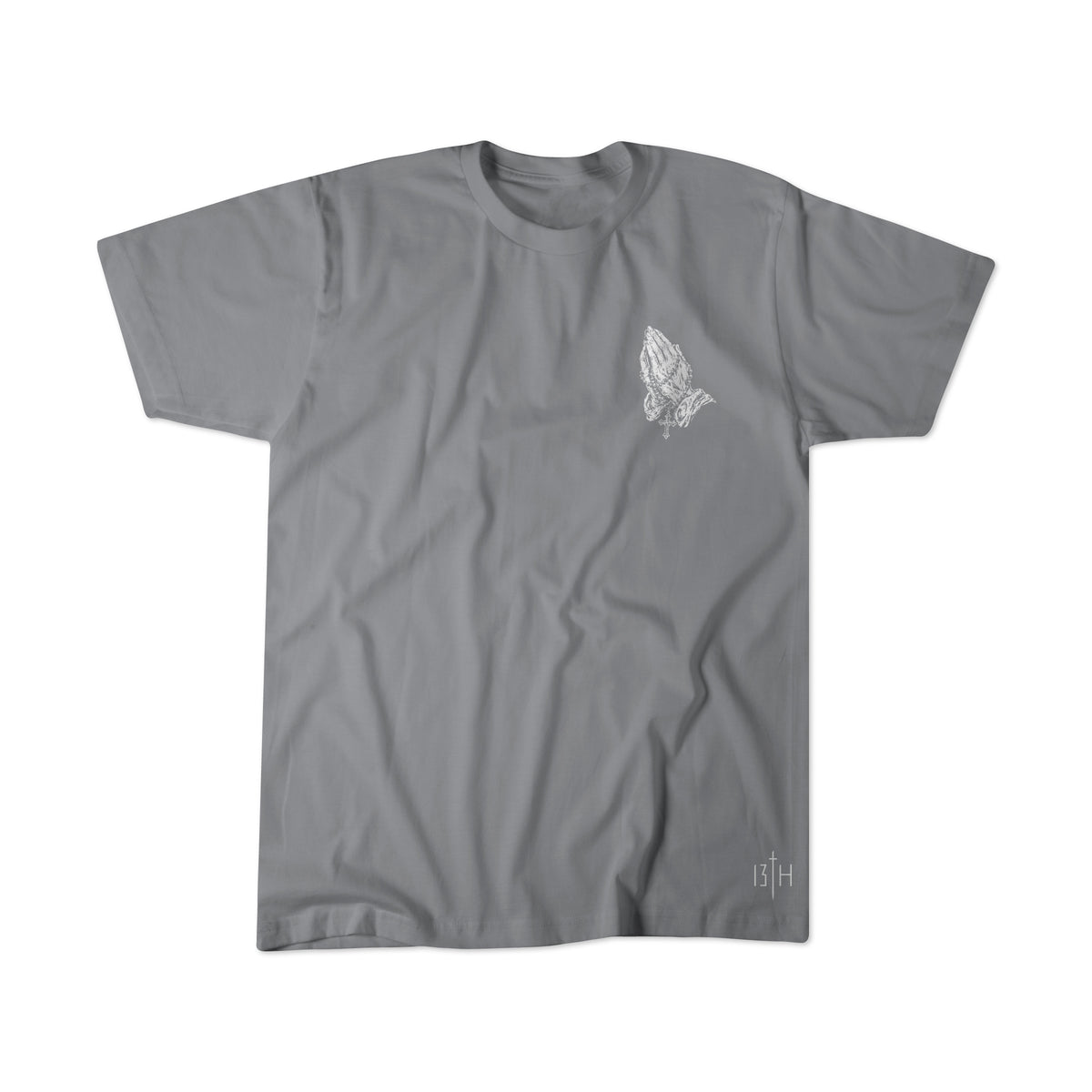 Grey 13th The Lord’s Prayer Premium Tee with a white line-art graphic of praying hands on the left chest and a small logo near the bottom hem.
