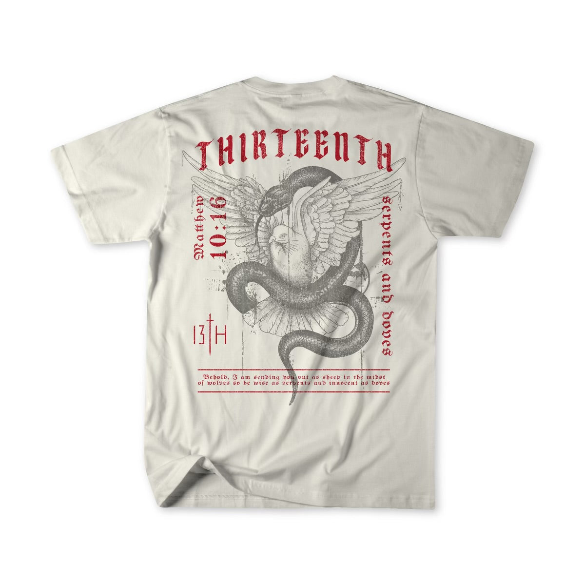 The Serpents And Doves Premium Tee by 13th is a beige T-shirt featuring a winged serpent with a skull. It displays red THIRTEENTH, the date 10.16, and the phrase “Between the Serpents and Doves,” inspired by Matthew 10:16 for wisdom and innocence.