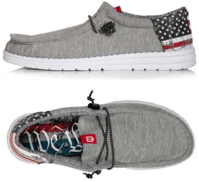 The Roam Flag - Gray by Howitzer Clothing is a casual gray slip-on with a white sole, American flag design, “We the People” details, black laces, and ultralight comfort—perfect unisex lightweight shoes for everyday wear.