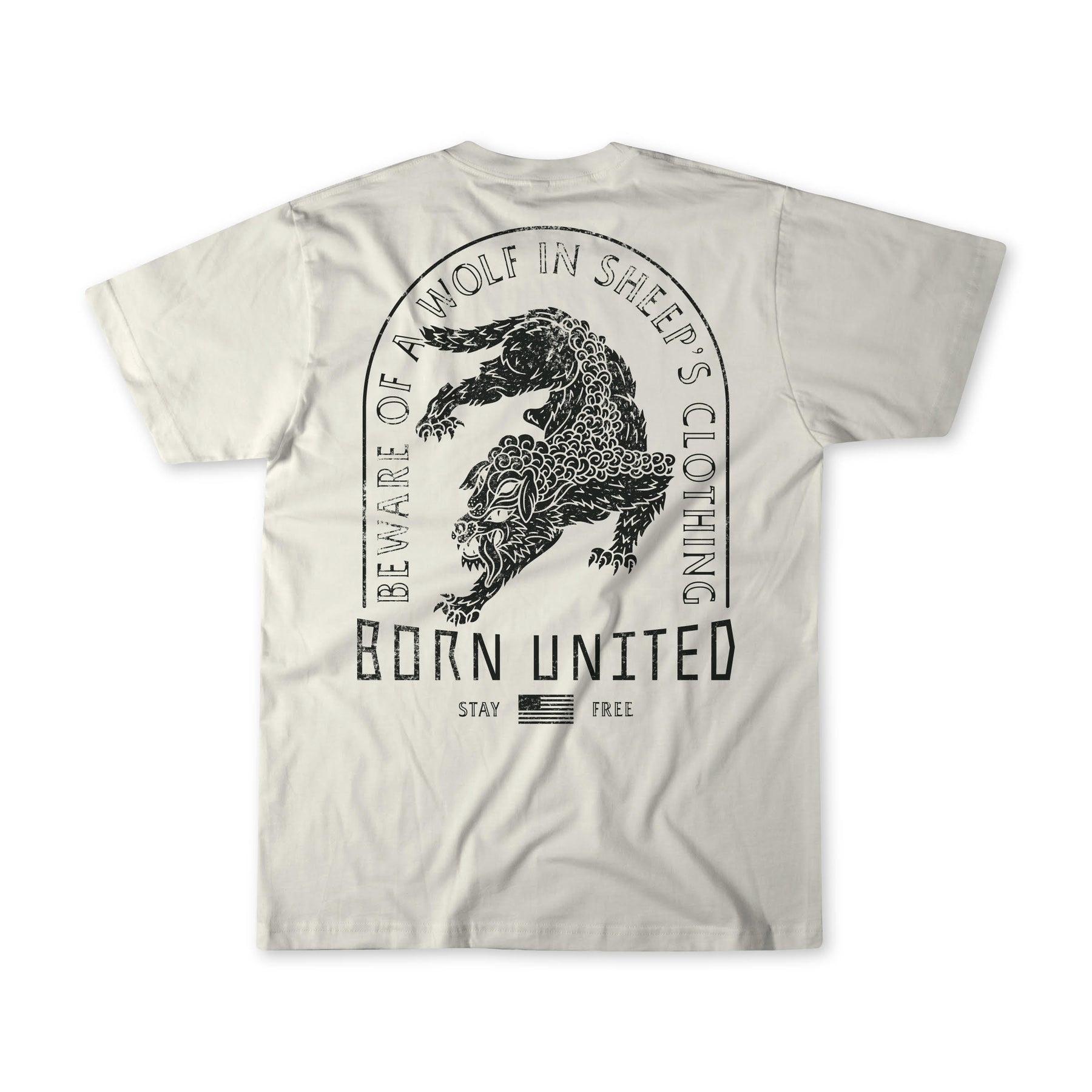 The Beware beige T-shirt by Born United Private Label features a black wolf in sheeps clothing with a leopard, and texts: BEWARE OF A WOLF IN SHEEPS CLOTHING, BORN UNITED, and STAY FREE above an American flag emblem—ideal for stylishly keeping deceit at bay.