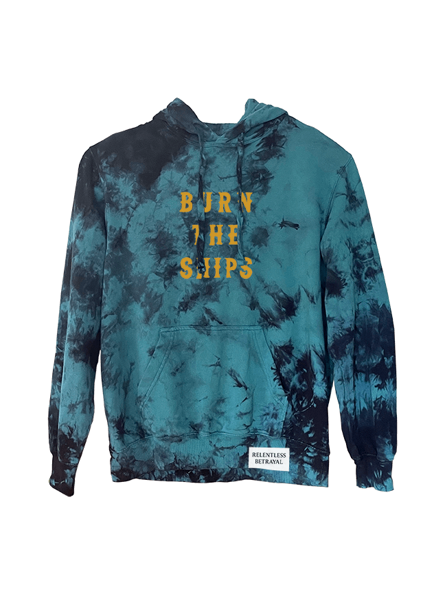 The Burn The Ships Tie Dye Hoodie from Relentless Betrayal boasts a vibrant blue with yellow text, crafted from a comfy cotton-polyester blend. It includes a hood, front pocket, and a white RELENTLESS RETREAT tag near the hem.
