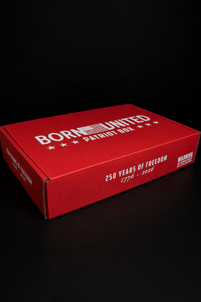 The Born United Patriot Box by Born United Private Label is a red rectangular box with "BORN UNITED PATRIOT BOX, 250 YEARS OF FREEDOM 1776-2026" in white text and a warning label. Ideal for collectors of Challenge Coins and Limited Edition Tees.