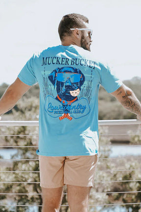 Man wearing a blue t-shirt with a graphic design, standing outdoors.