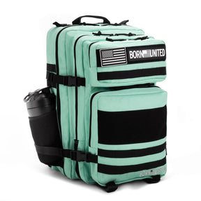The Mint Condition Premium Tac-Pac - 45L by Born United Private Label is a mint green tactical backpack with black straps, a side water bottle pocket, American flag and BORN UNITED patches, plus multiple compartments and zippers.