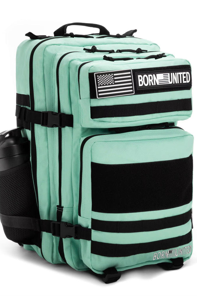 The Mint Condition Premium Tac-Pac - 45L by Born United Private Label is a mint green tactical backpack with black straps, a side water bottle pocket, American flag and BORN UNITED patches, plus multiple compartments and zippers.