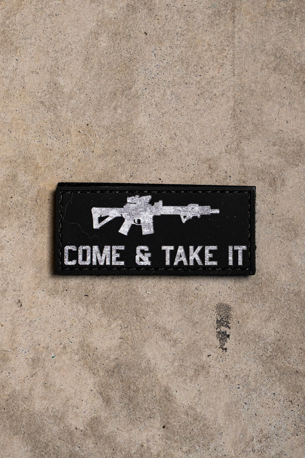 Born United Private Label Come and Take It PVC patch: a rectangular black patch with a white rifle silhouette above the text COME & TAKE IT.