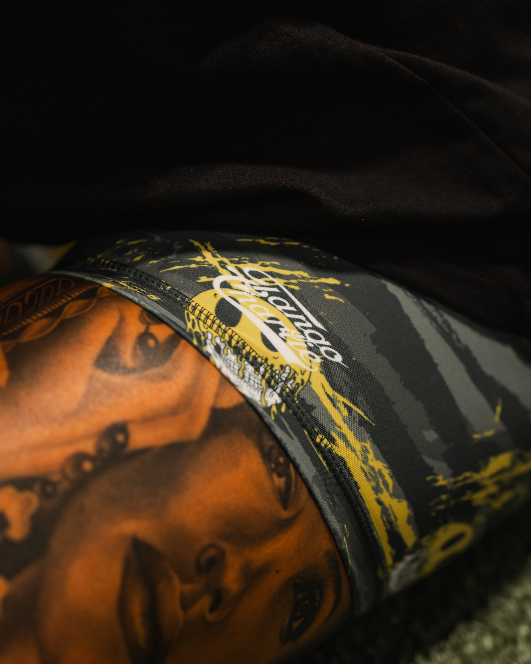 Close-up of Born United Private Label’s Womens High-Waisted Seamless Front Compression Training Shorts | Unleash the Savage, featuring a bold woman’s face print and “Sincerely Yours” script on black, gray, and yellow for standout workouts.