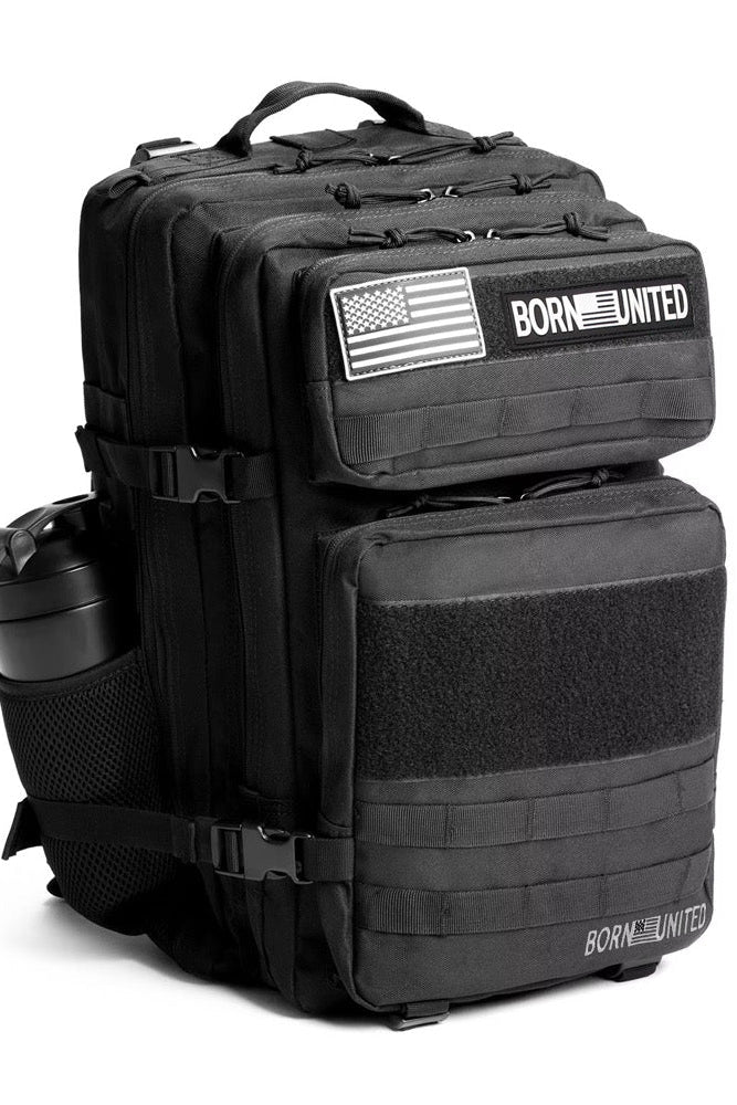 The Midnight Black Premium Tac-Pac - 45L by Born United Private Label features multiple compartments, two American flag patches, “BORN UNITED” text, and a water bottle in a side mesh pocket on a white background.