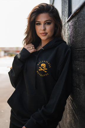 relentless betrayal - skull crossbones hoodie on women's model