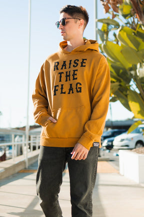 relentless betrayal - raise the flag premium toast hoodie front on male model