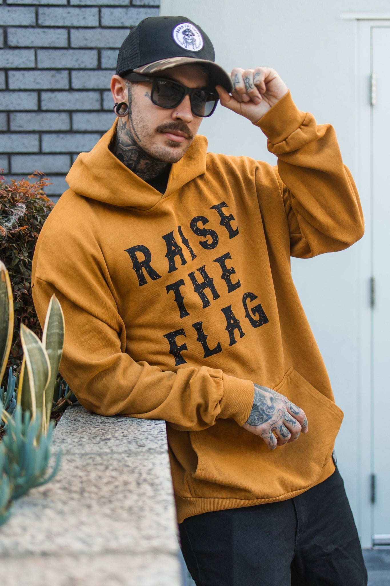 relentless betrayal - raise the flag premium toast hoodie front on men's model