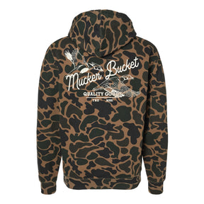 The Youth Wood Ducks Premium Duck Camo Hoodie by Mucker Bucket features a relaxed fit camo design with crossed duck calls, "Mucker Bucket," and "Quality Goods TRD MRK" in white on the back—perfect for young hunters.