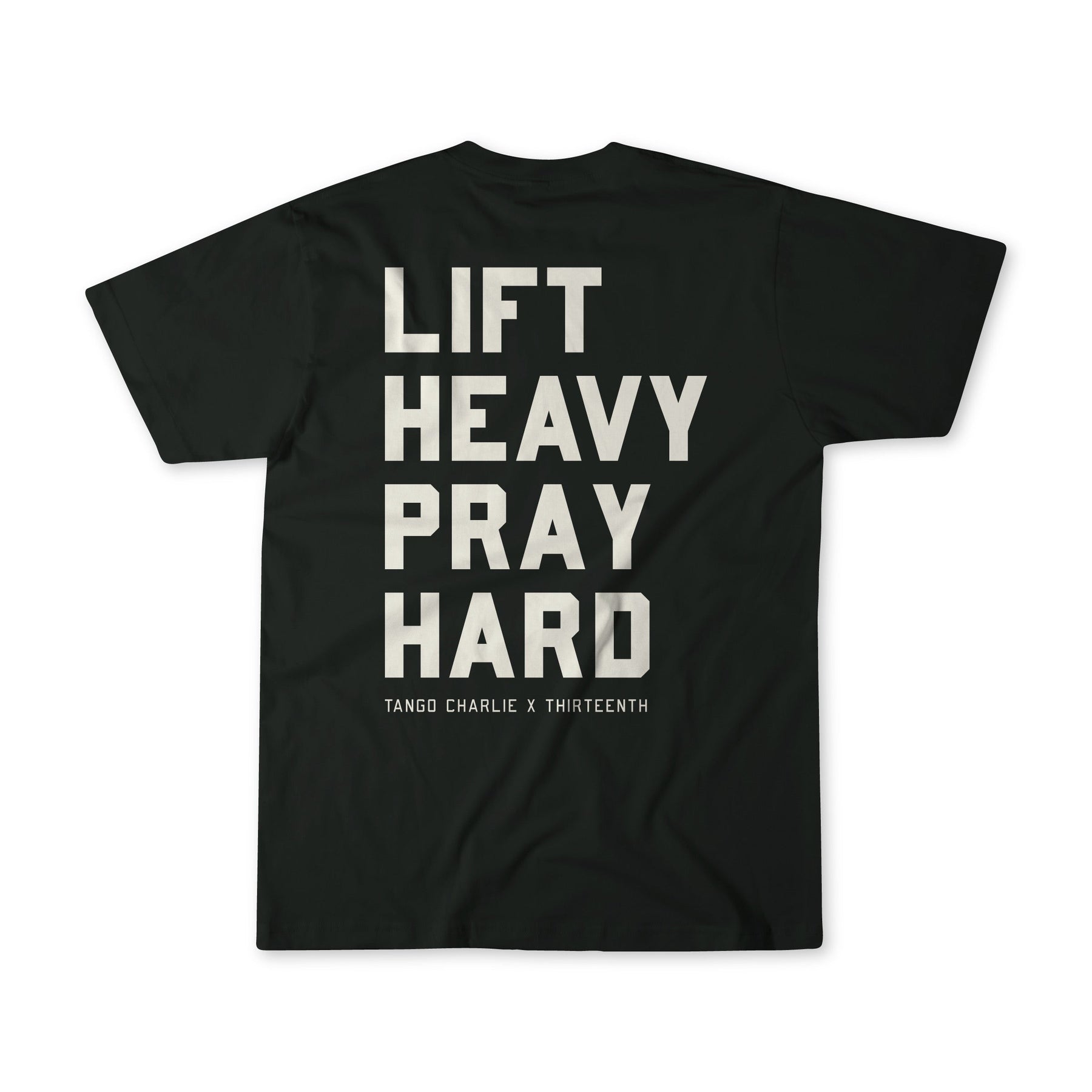 The Lift Heavy. Pray Hard. - Black Tee by Tango Charlie Apparel features bold white “LIFT HEAVY PRAY HARD” text on the back and “TANGO CHARLIE X THIRTEENTH” below, symbolizing resilience.