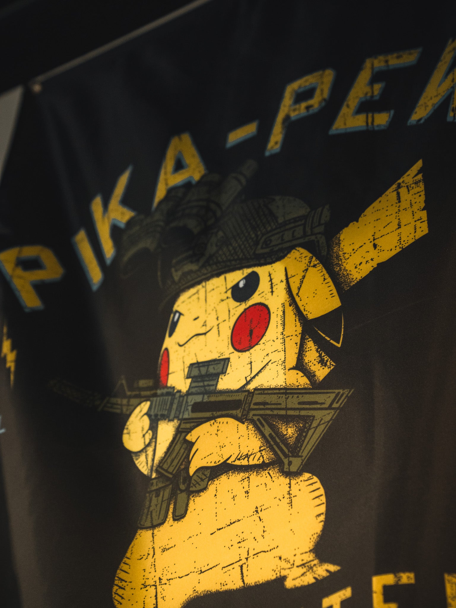 The Pika-Pew Flag by Born United Private Label features Pikachu in a military helmet with a rifle and distressed yellow “PIKA-” text—a must-have for tactical Pokémon collectors.