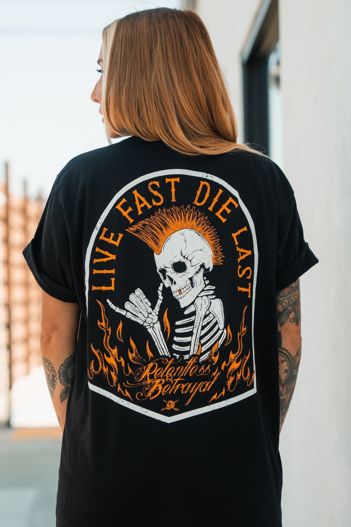 relentless betrayal - live fast black t-shirt on women's model