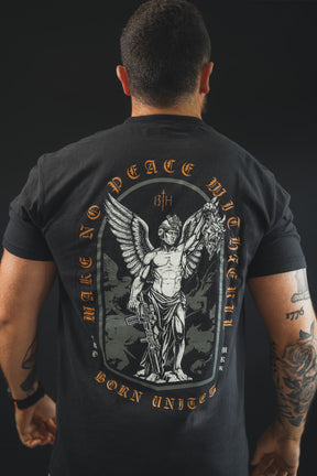 A tattooed man wears the Make No Peace Premium Tee by 13th, a black cotton shirt with a winged armored figure holding a severed head and bold "MAKE NO PEACE WITH THE 13TH BORN UNITED" text.