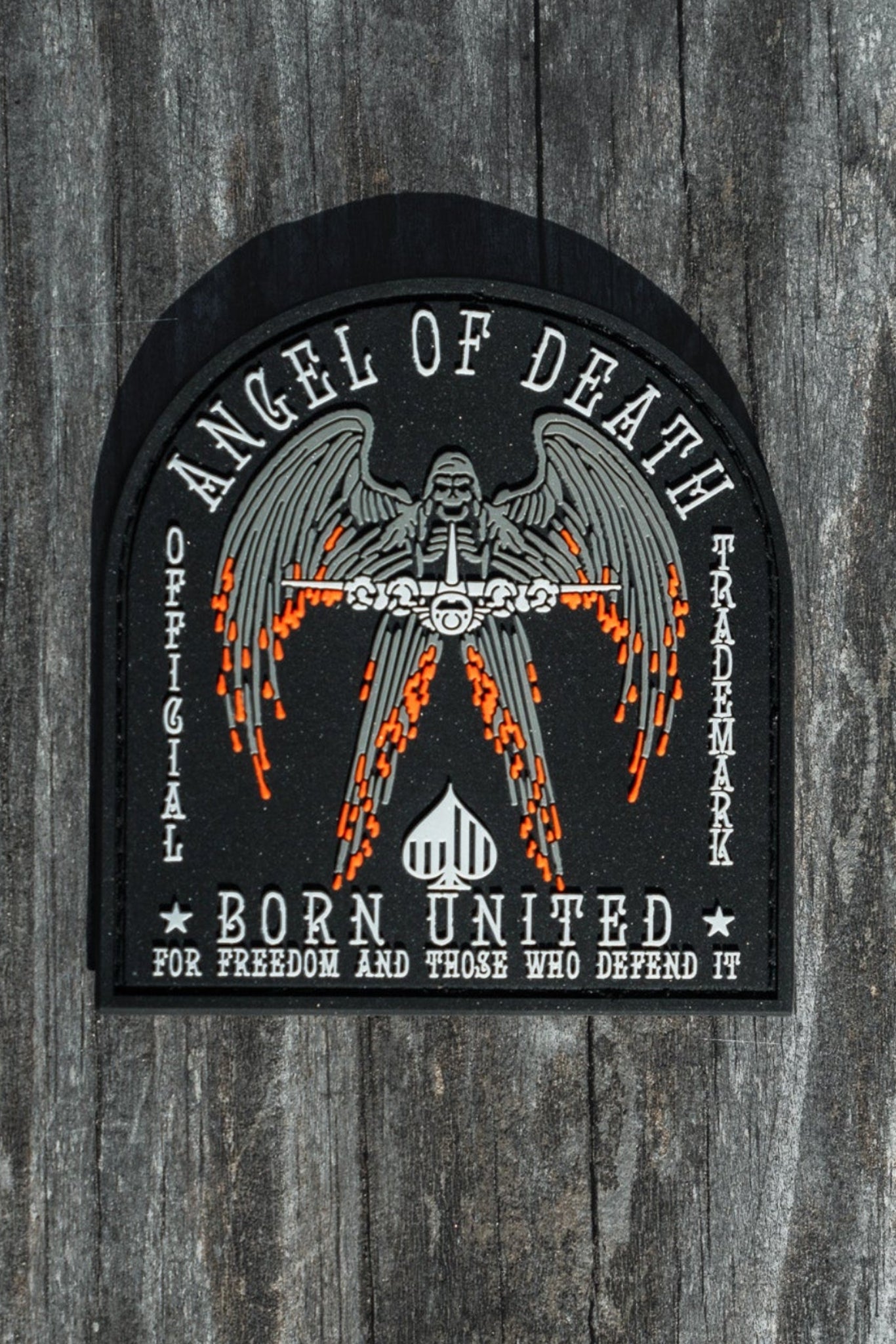The Angel Of Death PVC Patch from Born United Private Label features a winged figure with flaming swords and the words Angel of Death and Born United for Freedom and Those Who Defend It, designed in black, white, and orange.